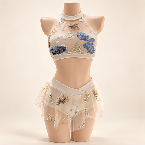 Bluebell Meadow Set on mannequin: halter crop top with embroidered blue floral mesh and high-waisted bottoms with embroidered tulle skirt